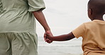 Mom, child and holding hands on beach for support, bonding and holiday with waves. Back of parent, mother or family with kid by the ocean, sea or water in winter for love, care and safety or security