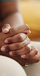 Closeup, hands and person with anxiety or nervous on sofa for mental health issue, depression and stress in home. Psychology, adult and waiting for therapy with fear, uncomfortable and distress  