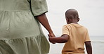 Mother, child and holding hands on beach for support, bonding and holiday with closeup. Back of parent, mom or family with kid by the ocean, sea or water in nature for love, care and explore together