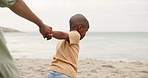 Parent, child and holding hands on beach for support, bonding and holiday by ocean waves. Family and african kid walking to sea or coast with help and guide on vacation, travel and playing game