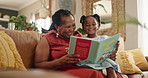 Grandmother, child and reading a book in living room, home and fiction for storytime on weekend. Black family, love and bonding on literature or literacy, joy and fairytale for education and language