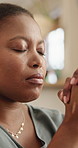 Prayer, worship and black woman in home for faith, spiritual and praise God in lounge. Religion, hope and person with eyes closed for Christianity, gratitude and meditation with Jesus Christ closeup