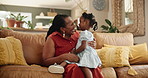 Grandmother, child and hug or communication in home, affection and bonding or care in living room. Black family, grandkid and grandma on couch and happy on weekend, conversation and embrace in lounge