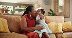 Grandmother, child and kiss or hug in home, affection and bonding or care in living room. Black family, love and grandma on couch and happy on weekend, laughing and funny humor or playful in lounge