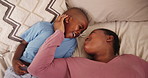 Mother, young boy and top view in bedroom with love for bonding, affection and security with comfort in home. Black family, mom and son with happiness on bed for relax and weekend break in morning 