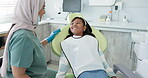 Dentist, woman and kid consulting for dental, health and teeth cleaning service with medical advice or support. Orthodontist or doctor talking to kid or girl of tooth with happy or funny conversation