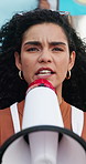 Woman, face and megaphone to scream for protest for civil or human rights, empowerment and speech for change or peace. Vertical, march and microphone for voice for riot, equality and social justice.