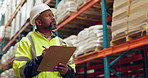 Walking, warehouse and black man with clipboard for inspection, inventory and check stock. Shipping, distribution and person writing checklist for logistics, maintenance and manufacturing in factory