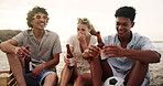 Laughing, beer and friends at beach for summer vacation, weekend trip or outdoor party in nature. Alcohol, funny and diverse group of people at sea for holiday, sunshine and hangout for on sand