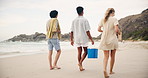 Friends, walking and feet by sea on holiday, footprints and bonding together on adventure by ocean shore. Men, woman and diversity with foot on sand, back and cooler box with drinks for beach party