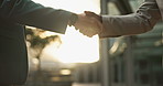 Business people, sunset and handshake for agreement in city, networking and introduction outdoors. Professionals, dusk and welcome in recruitment or communication, closeup and hire for collaboration