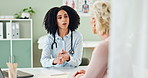 Doctor, patient and consultation for healthcare with script for prescription, medicine and advice for treatment. Women in office for medical care, discussion and writing note for pharmacy with help