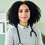 Happy, crossed arms and face of woman doctor in office at hospital with ...