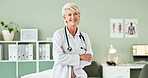 Happy, crossed arms and face of senior doctor in office at hospital with pride and confidence. Smile, professional and portrait of woman healthcare worker with positive attitude in medical clinic.