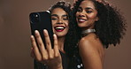 Happy woman, friends and selfie with makeup in fashion for party, glamour or memory on a brown studio background. Female person or people with smile in stylish clothing for photography or picture