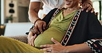 Hands, couple and happy for pregnancy with bonding for care, support and love at home. Living room, future mother and father for maternity with smile for tummy touch and together for affection