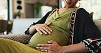 Pregnant woman, touch and love on stomach on sofa and happy with maternity support or prenatal care. Mother, smile and connect with fetus with gratitude, pregnancy and bonding with baby in apartment