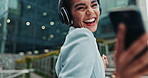 Businesswoman, headphones and dancing music for cellphone playlist, streaming or commute. Female person, happy and smartphone or urban city building in New York with internet, audio or stress relief