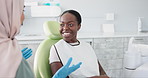 Happy woman, dentist and patient with consultation for teeth cleaning, treatment or dental care at clinic. Young female person or orthodontist consulting customer for oral, gum or tooth whitening