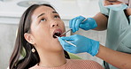 Asian woman, dentist and patient with clinic tools for cleaning mouth, oral or gum in dental care. Face of female person in relax with orthodontist for tooth whitening, hygiene or removing cavity
