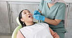 Woman, dentist and patient with clinic tools for cleaning mouth, oral or gum in dental care. Face of Asian or female person in relax with orthodontist for tooth whitening, hygiene or removing cavity