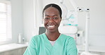 Face, smile and dentist with black woman in scrubs at hospital for dental care or oral hygiene. Portrait, healthcare or medical with happy young orthodontist professional at clinic for dentistry
