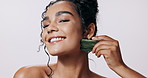 Happy, skincare and woman in studio with gua sha for facial massage, relax and beauty with glow. Dermatology, cosmetics and jade face tool for self care, smooth skin and wellness on white background