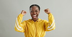 Face, excited and black woman with celebration, cheering or success on grey studio background. Portrait, person or winner with victory or achievement with lottery or smile with expression or giveaway