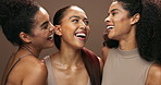 Face, women and group with skincare, cosmetics and laughing on a brown studio background. Models, friends and girls with wellness and dermatology with luxury and funny with healthy skin and beauty
