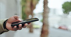 Phone, text and man hands in the city with app, internet and social media on a road. Urban, street and male professional with tech and scroll on a maps website and online with travel on a sidewalk