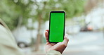 Green screen, phone and hands in a city for travel, search or direction, navigation or online map. Smartphone, mockup or person with app for journey guide, planning or taxi, cab or chauffeur service