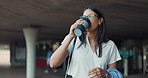 Woman, walking and employee drinking coffee with morning, commute and travel with smile under bridge. Urban, city and happy professional with thinking and ready to start work with vision outdoor