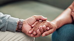 Care, holding hands and senior couple in living room together with love, comfort and connection in home. Marriage, old man and woman at coffee table with support, kindness and respect in retirement