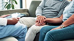 Couple, hands and nurse talking with tablet on sofa at home for healthcare, advice or retirement plan. Elderly man and woman holding hands or listening to medical caregiver with technology at house