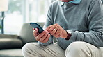 Hand, cellphone and texting on sofa at home for online communication or searching, technology or chatting. Person, fingers and smartphone in living room for internet connection, message or typing