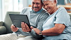 Tablet, couch and senior couple with meme, social media and game with bonding and care. Retirement, home and streaming on a website or internet in a living room with tech and watching a video