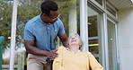 Nursing home, conversation and black man with elderly woman, person with a disability and rehabilitation. Recovery, old lady and pensioner with caregiver and wheelchair with help, support and healing