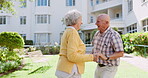 Senior couple, happy and dancing outdoors, retirement and celebrate a marriage milestone on grass. Elderly people, garden and moving on lawn of nursing home, romance and anniversary of love on date