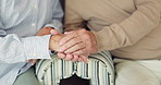 Senior people, holding hands and support in closeup on sofa for love, care and empathy for bonding in retirement. Elderly person, couple and together on lounge sofa with connection in nursing home