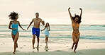 Excited, friends and running on sand at beach for freedom, adventure or weekend trip in Florida. Travel, celebration and happy people by ocean water for summer holiday, getaway or vacation together
