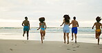 Summer, friends and running to water at beach for holiday, weekend trip or adventure in Bali together. Travel, sunset and group of people on sand for vacation getaway, freedom and wellness with ocean