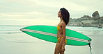 Beach, surfing in summer and woman walking with surfboard on sand by sea or ocean for travel. Smile, bikini and morning with happy young surfer person n coast for sports, training or leisure hobby