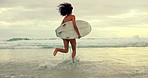 Woman, surfer and running with water splash on beach for waves, sport or outdoor surfing in nature. Rear view of female person on ocean coast or sea for surfing, holiday or weekend with surfboard
