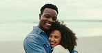 Hug, happy and face of couple at beach on holiday, vacation or travel for romantic date together. Love, smile and interracial young man and woman embracing by tropical ocean or sea on weekend trip.