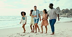 Smile, summer and friends walking on beach together for travel, holiday or vacation at tropical coast. Happy, love or smile and group of young men and women bonding by ocean or sea for island getaway