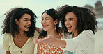 Women, talking or friends hug on beach for a fun holiday vacation for walking on trip together. Smile, laughing or group of people on adventure for wellness, support or conversation with love or care