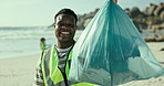 Portrait, beach and black man with a trash bag, environment and climate change with plastic collection and ecology. Face, teamwork or seaside with guy or volunteer with sustainability or eco friendly