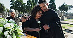 Hug, support or couple in graveyard for funeral, spiritual service or farewell burial in Christian ceremony. Woman, depressed man or sad people in cemetery for grief, loss or mourning death together