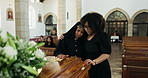 Grief, loss and women hug at coffin empathy at memorial service at church for respect, support and comfort. Death, funeral and widow with girl, memory and prayer at casket for spiritual farewell.