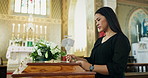 Funeral, rose and sad woman in a church, coffin and depression with ceremony and grief with religion. Person, girl ans coffin with loss of a loved one and flower with death and mourning with casket